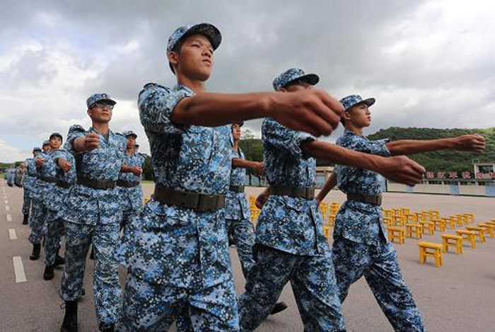 The picture shows Hong Kong teenagers attend a graduation ceremony of the military summer camp on July 28, 2013.  (Photo by Lyu Xiaowei)