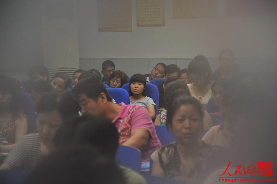 A parent teacher meeting is held on July 12, 2013 to release the results of the senior high school entrance examination. Gao participated in the meeting instead of her parents as usual. (Xinhua/Hu Linyun)