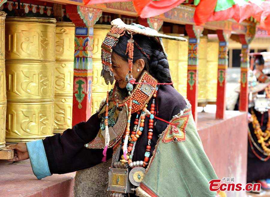 A Tibetan woman in traditional 'peacock costume' in a village of Burang County, Ngari Prefecture. Each of seven families in the village keeps such a costume handed down from hundreds of years ago. (CNS/Li Lin)
