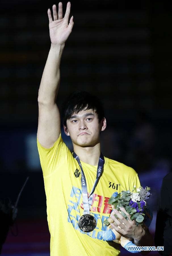 Sun Yang of China greets spectators after the awarding ceremony of the men's 800m freestyle final of the swimming competition at the 15th FINA World Championships in Barcelona, Spain on July 31, 2013. Sun Yang won the gold medal with 7 minutes and 41.36 seconds. (Xinhua/Wang Lili)