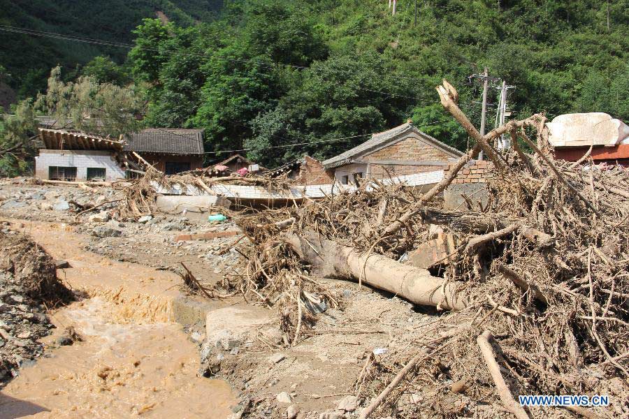 Photo taken on July 31, 2013 shows the Niangniangba Town destroyed by floods in Qinzhou District of Tianshui City, northwest China's Gansu Province. More than 20 people were dead or missing and about 1.22 million people were affected by the landslides and floods caused by strong rainfall in Tianshui in recent days. (Xinhua/Bai Liping)