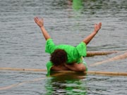 Stunt performance on floating bamboo stick