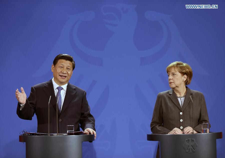 Chinese President Xi Jinping (L) and German Chancellor Angela Merkel attend a joint press conference in Berlin, Germany, March 28, 2014. (Xinhua/Lan Hongguang)