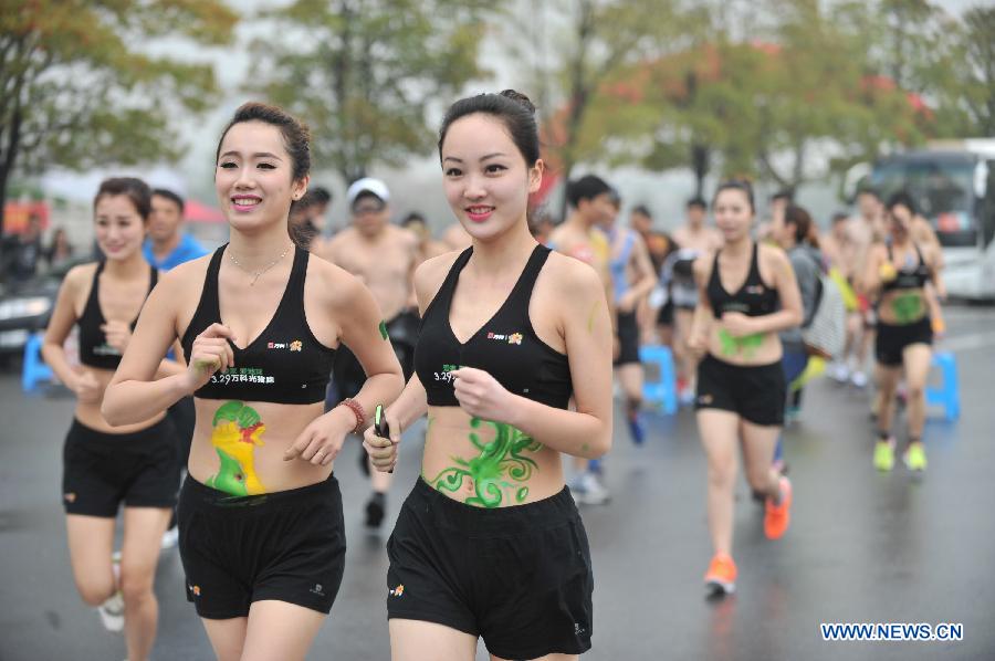People wearing underwear take part in a running race in Nanjing, capital of east China's Jiangsu Province, March 29, 2014. A special race was held here on Saturday, in which participants wore only underwear so as to advocate the 2014 Earth Hour event and promote the concept of green lifestyle. (Xinhua/Shen Peng) 