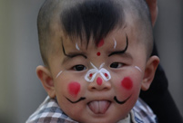 Little painted faces at temple fair
