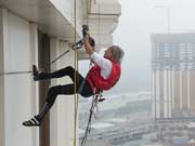 French Spiderman Alain Robert climbs up Galaxy Hotel in Macao