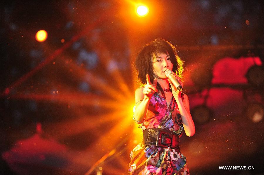 Hong Kong film star Maggie Cheung performs during the 2014 Strawberry Music Festival in Beijing, capital of China, May 3, 2014. The 3-day festival was held here from May 1 to 3. (Xinhua/Xiao Xiao)